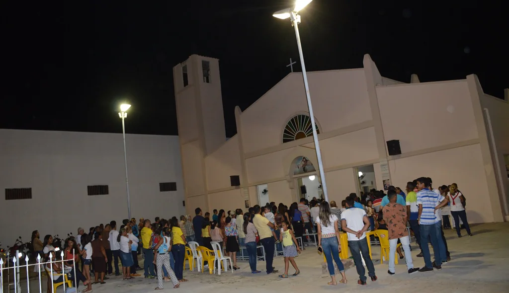 Por causa da lotação muitos fiéis acompanham a missa do lado de fora da igreja