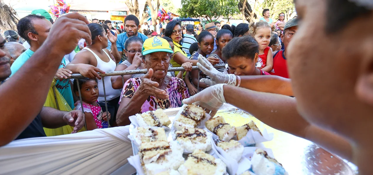 Público recebendo o bolo de comemoração ao aniversário de Teresina