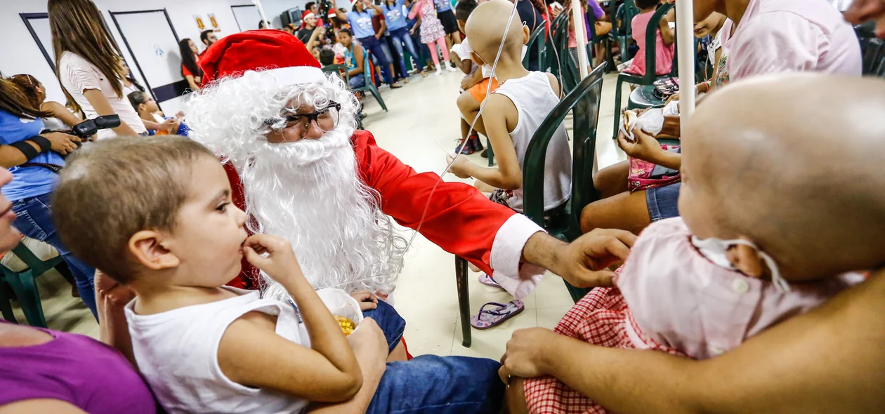 Papai Noel dando carinho as crianças com câncer 