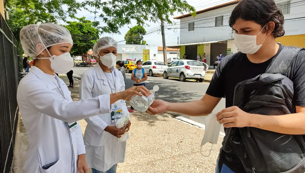 Estudante higieniza as mãos antes de entrar no local de prova do Enem
