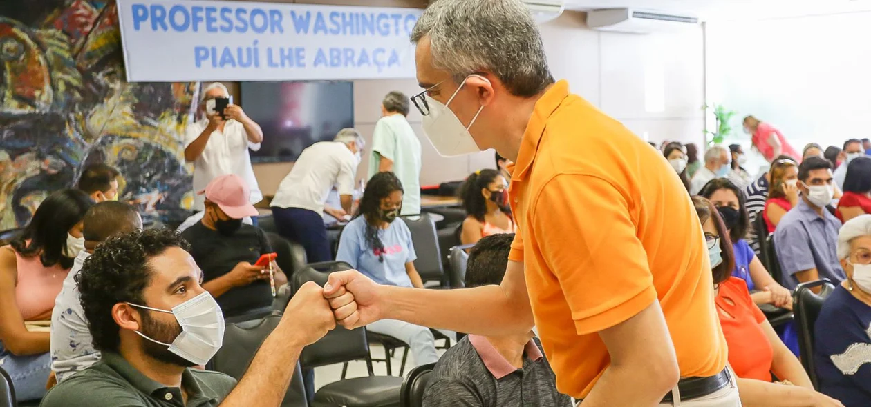 Washington Bonfim cumprimentando jovem durante sua filiação