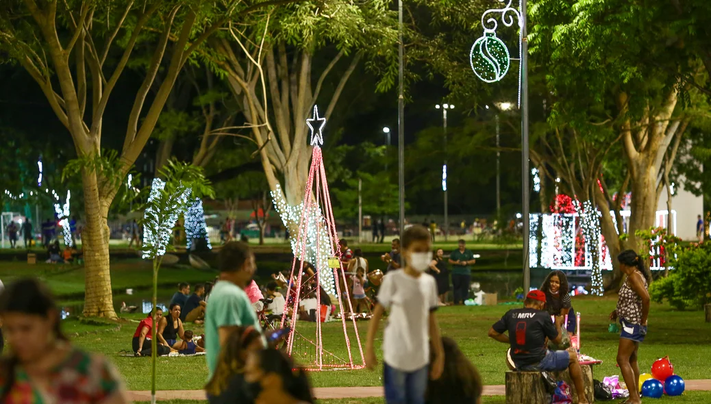 Crianças brincam ao lado da decoração natalina no Parque da Cidadania