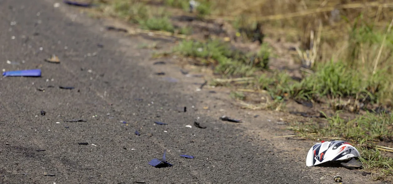 Pedaços da motocicleta na pista