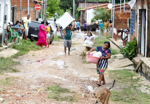 Famílias retiram seus pertences das casas alagadas devido a fortes chuvas em Teresina