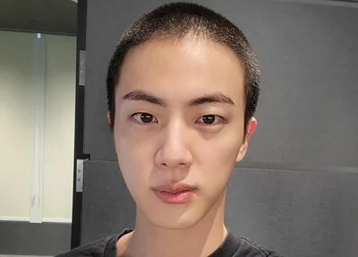 Membro do BTS, Jin posta foto com cabeça raspada