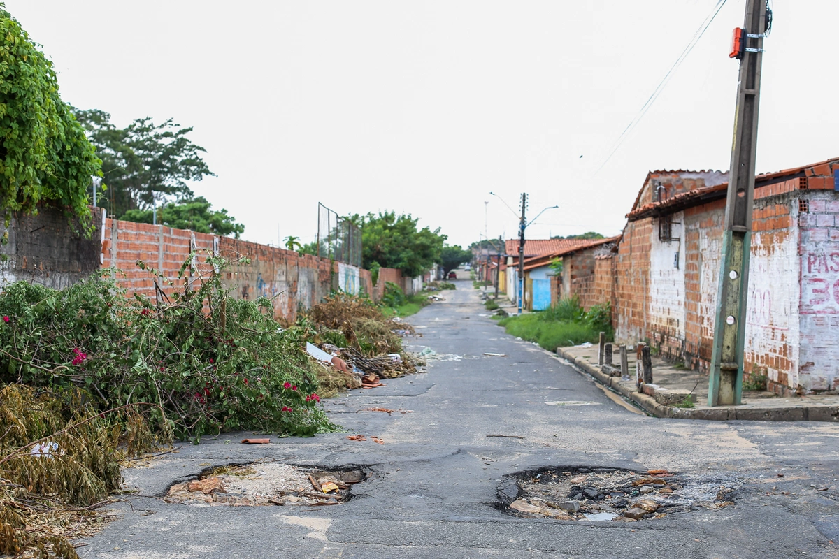 Rua cheia de buraco e lixo