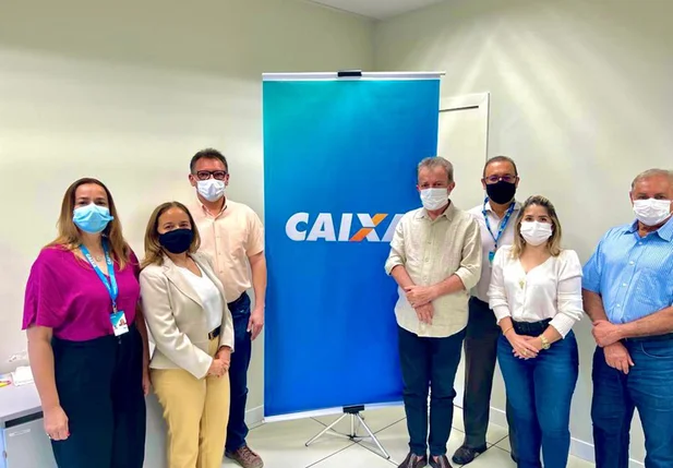 O prefeito Joãozinho Félix ao lado da secretária de Habitação e do construtor, na Superintendência Estadual da CEF