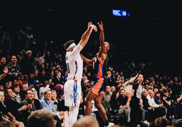 Seth Curry realizando arremesso para bola de três pontos