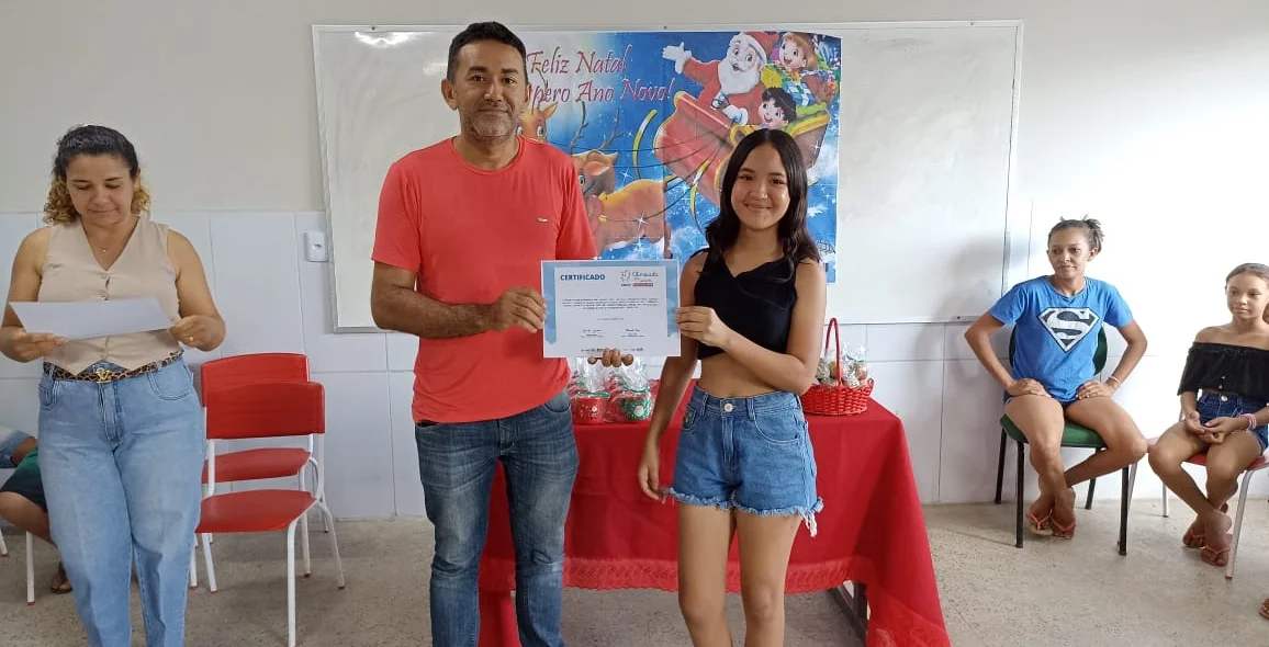 Aluna da rede municipal recebendo o certificado