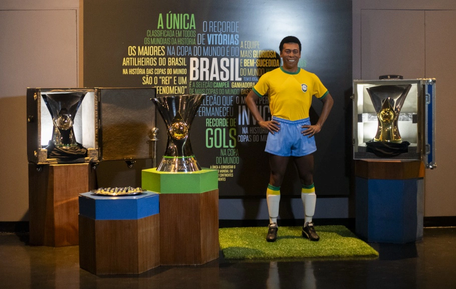 As três taças do Brasileirão Rei ao lado da estátua de Pelé