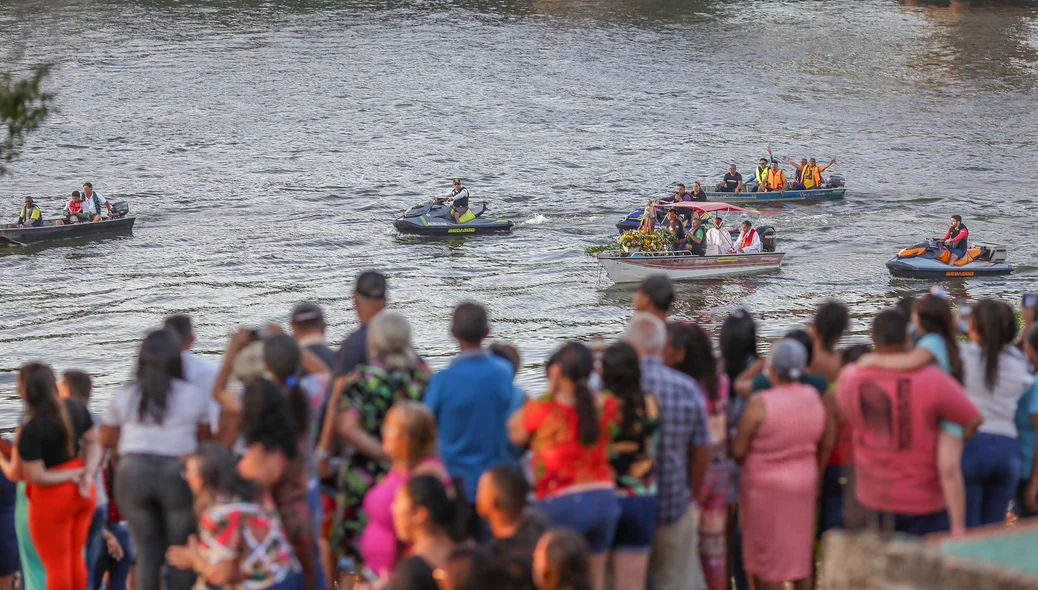 Fiéis na beira do rio aguardam a chegada da imagem do santo