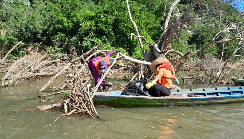 Pescadores realizando a coleta do lixo