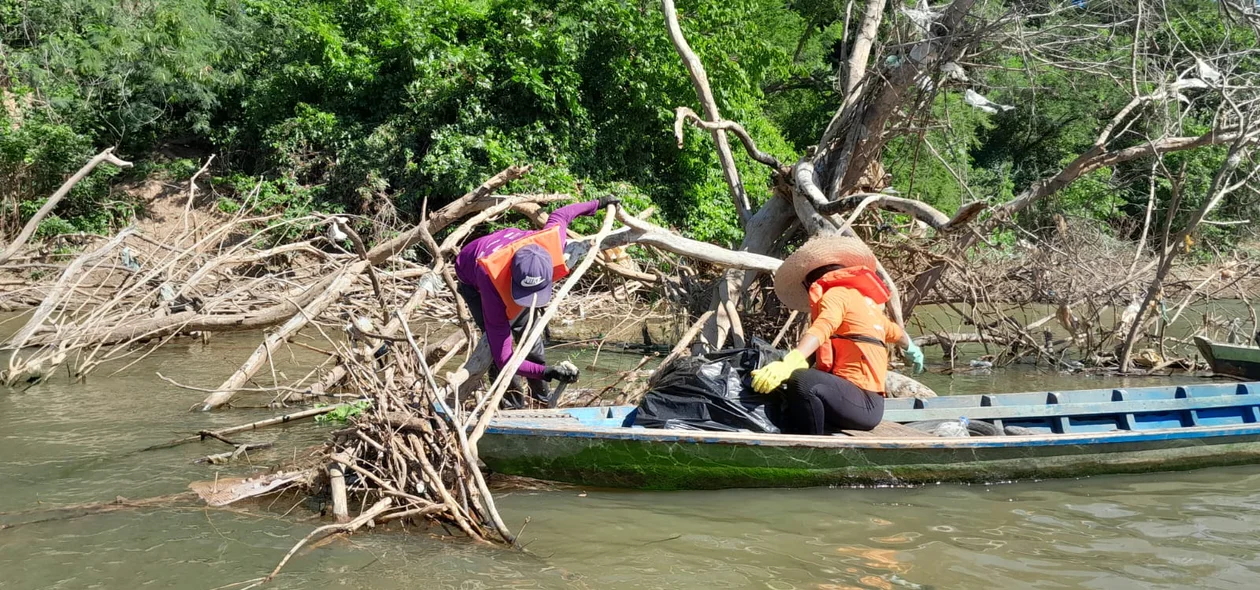 Pescadores realizando a coleta do lixo