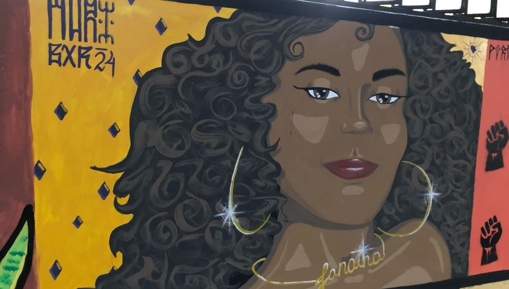Imagens de Janaína Bezerra pintada em um mural do DCE
