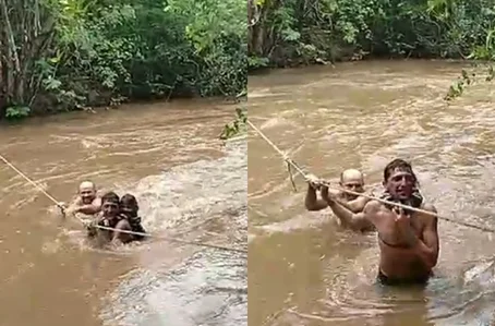 Moradores de Milton Brandão atravessando rio por meio de corda