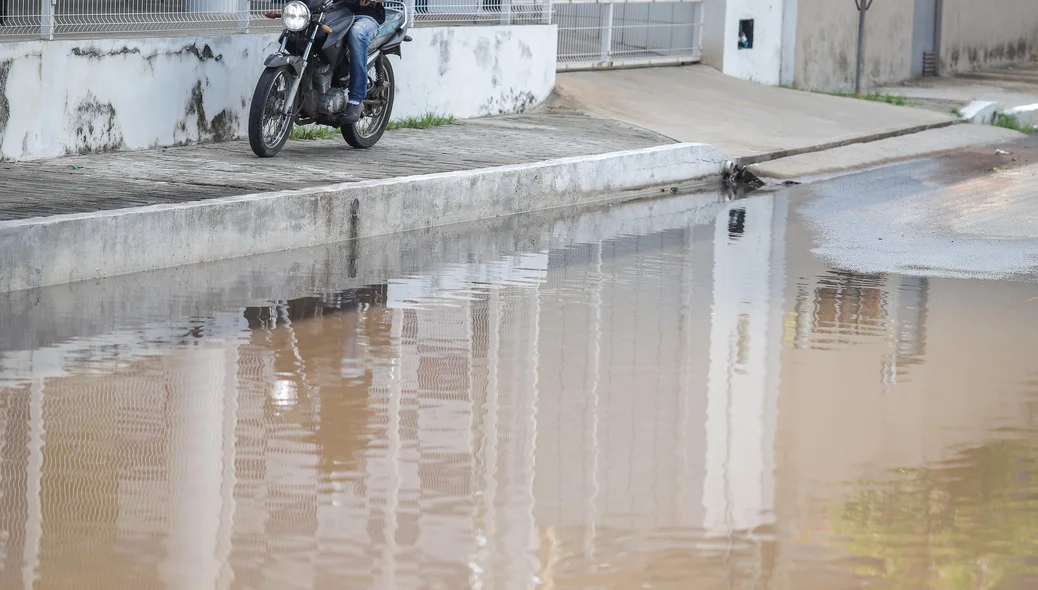 Motocicleta sobre calçada para fugir de alagamento causado por vazamento d'água