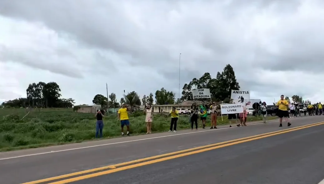 Manifestantes erguem faixas em em apoio a Bolsonaro
