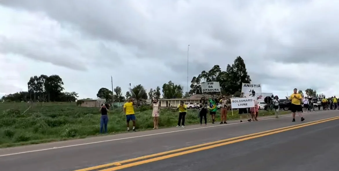 Manifestantes erguem faixas em em apoio a Bolsonaro