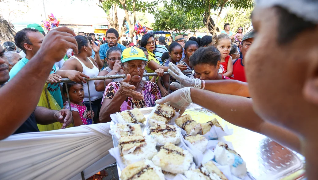 Público recebendo o bolo de comemoração ao aniversário de Teresina