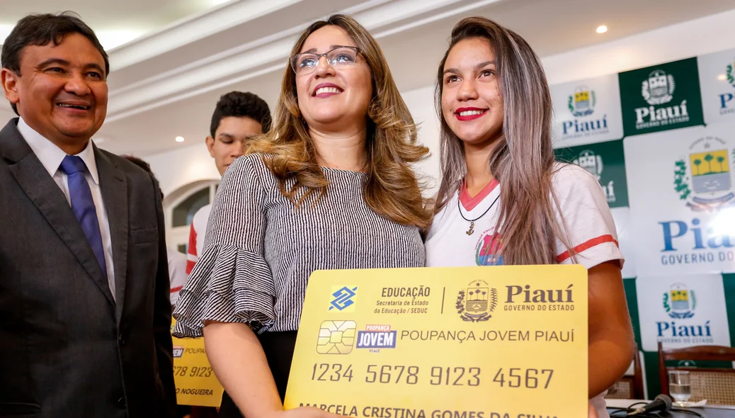 Secretária entrega prêmio para aluna 