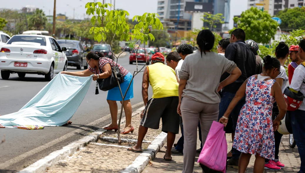 Populares tentando reconhecer o corpo