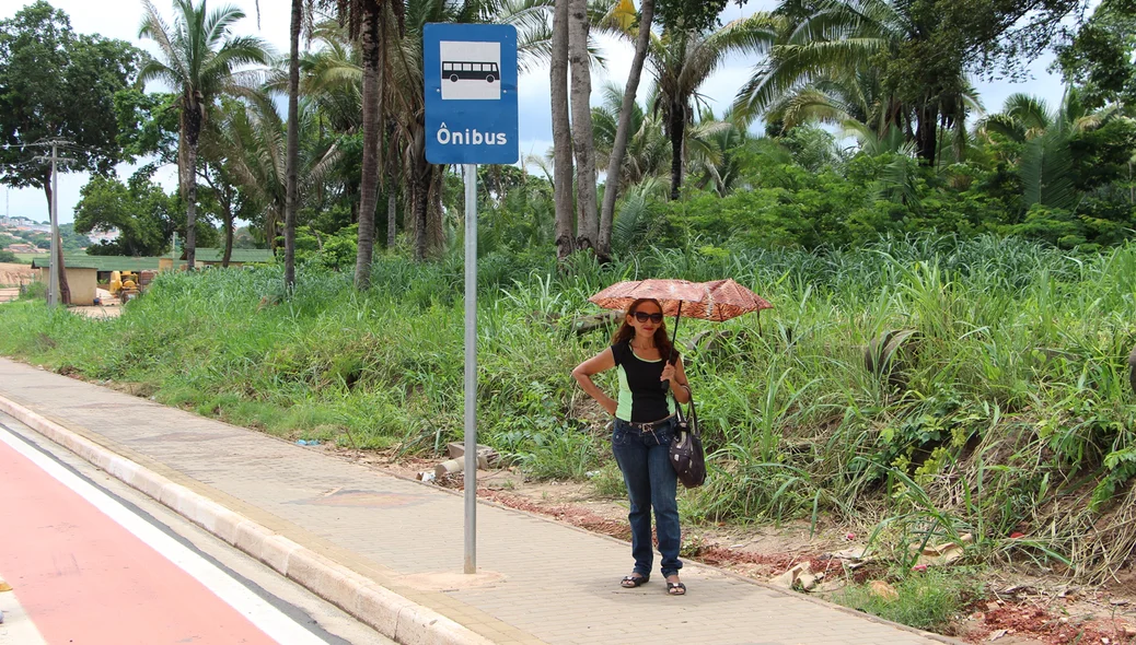 Passageira espera ônibus sem cobertura nas paradas