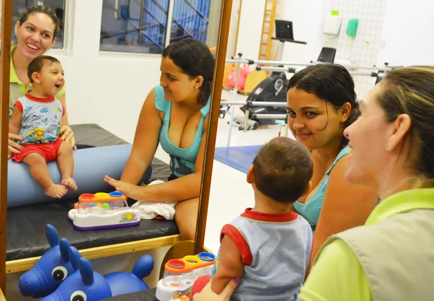 Assistente Social juntamente com criança com microcefalia