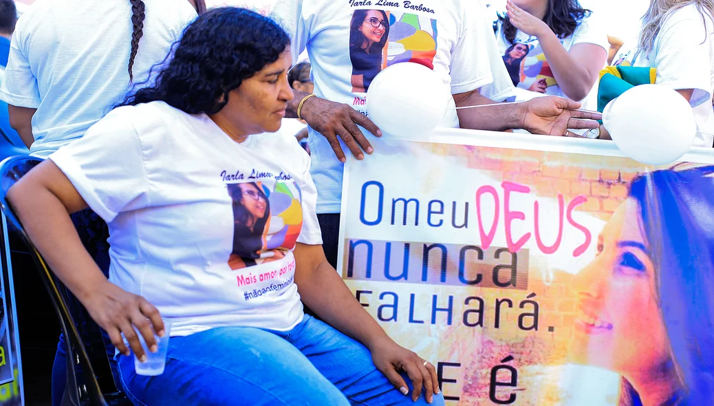 Dulcineia Lima da Silva olhando fotografia da filha 