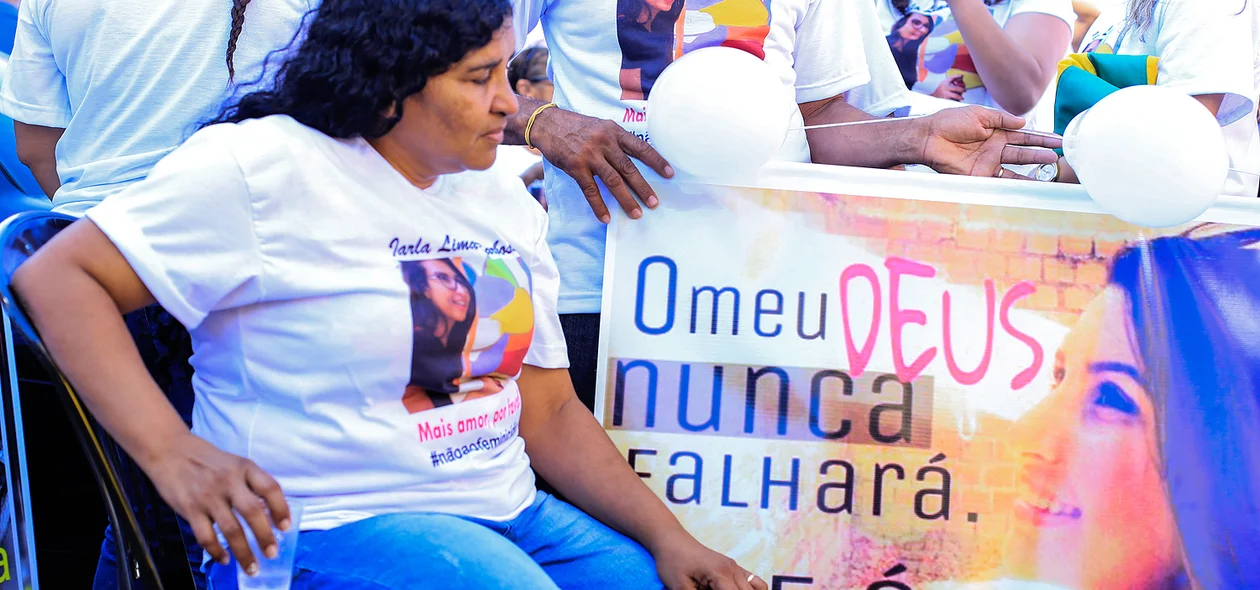 Dulcineia Lima da Silva olhando fotografia da filha 