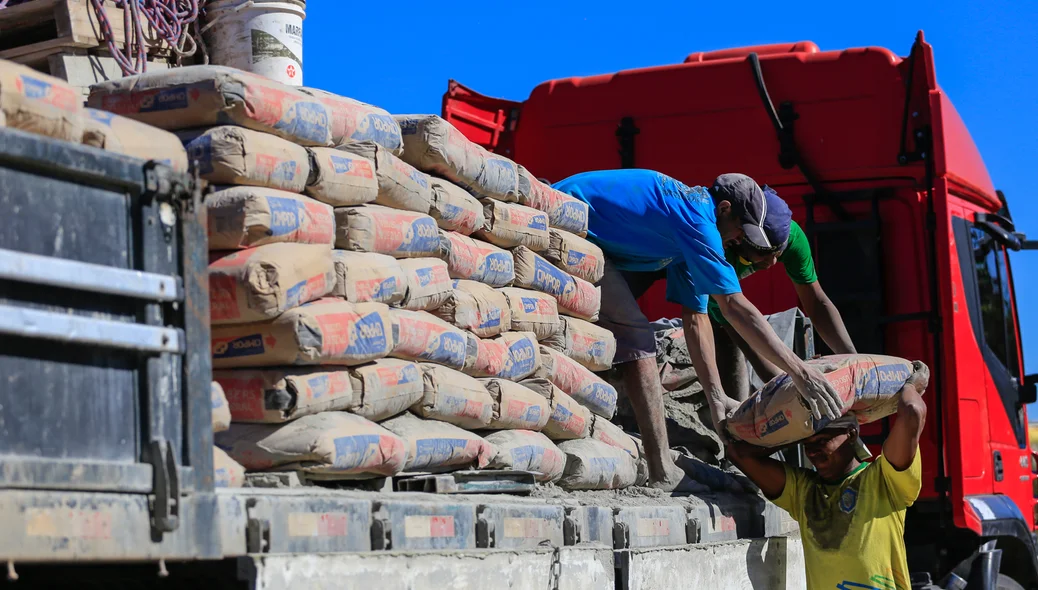 Trabalhadores recolhendo o material caído na pista 