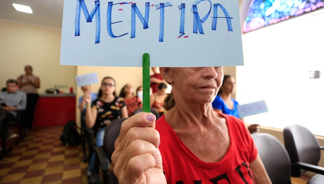 Moradores com cartazes de mentira 
