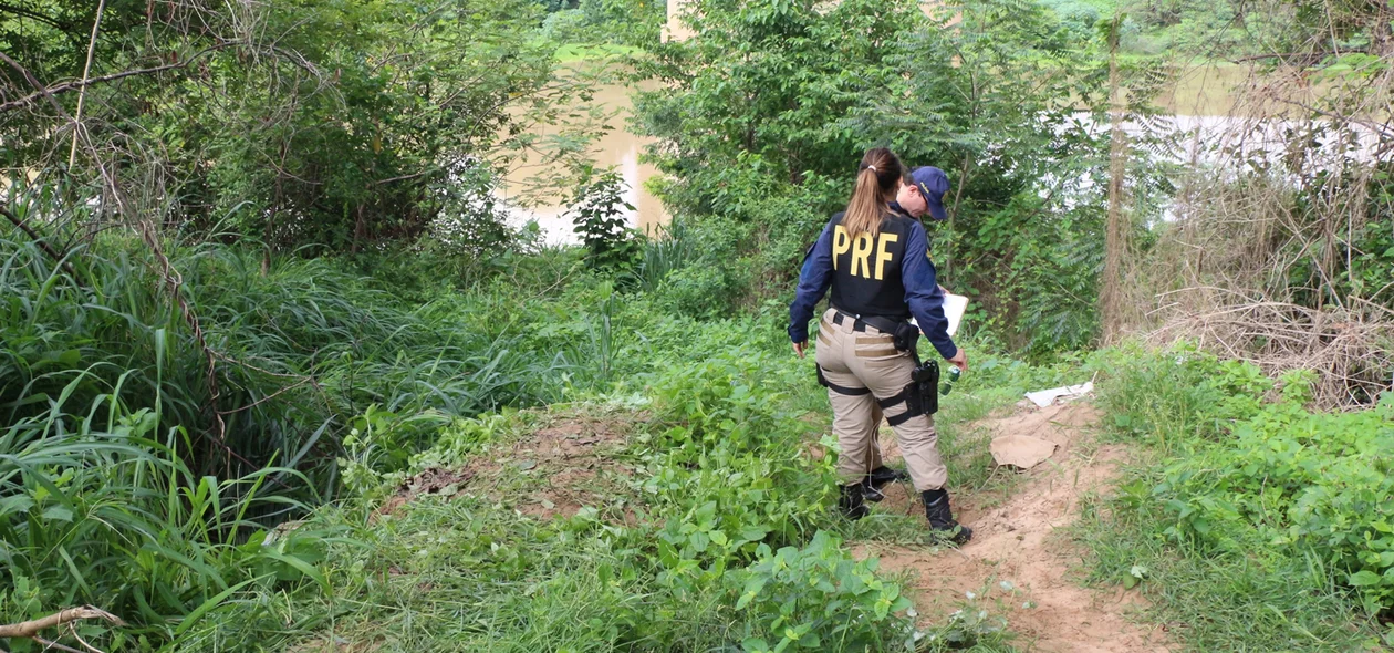 Policiais da PRF fazem levantamentos no local onde o corpo caiu