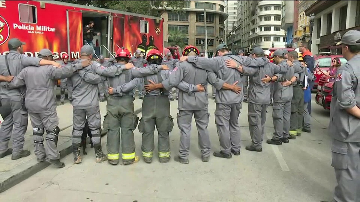Bombeiros fazem oração após término do trabalho de buscas no desabamento do prédio