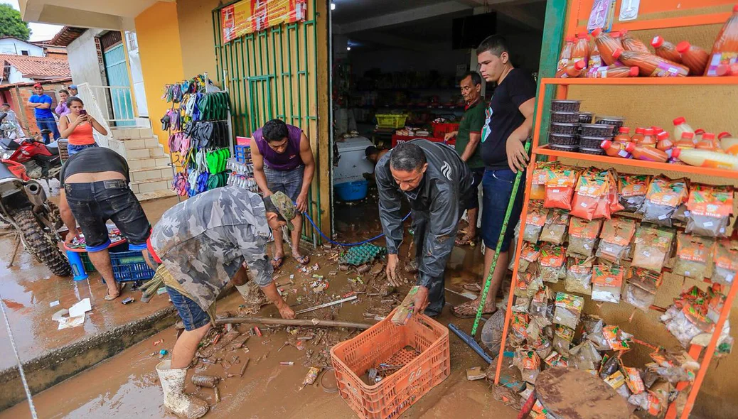 Moradores tiram muita lama de estabelecimento comercial após enxurrada no Parque Rodoviário