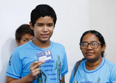 Criança autista recebendo a carteirinha