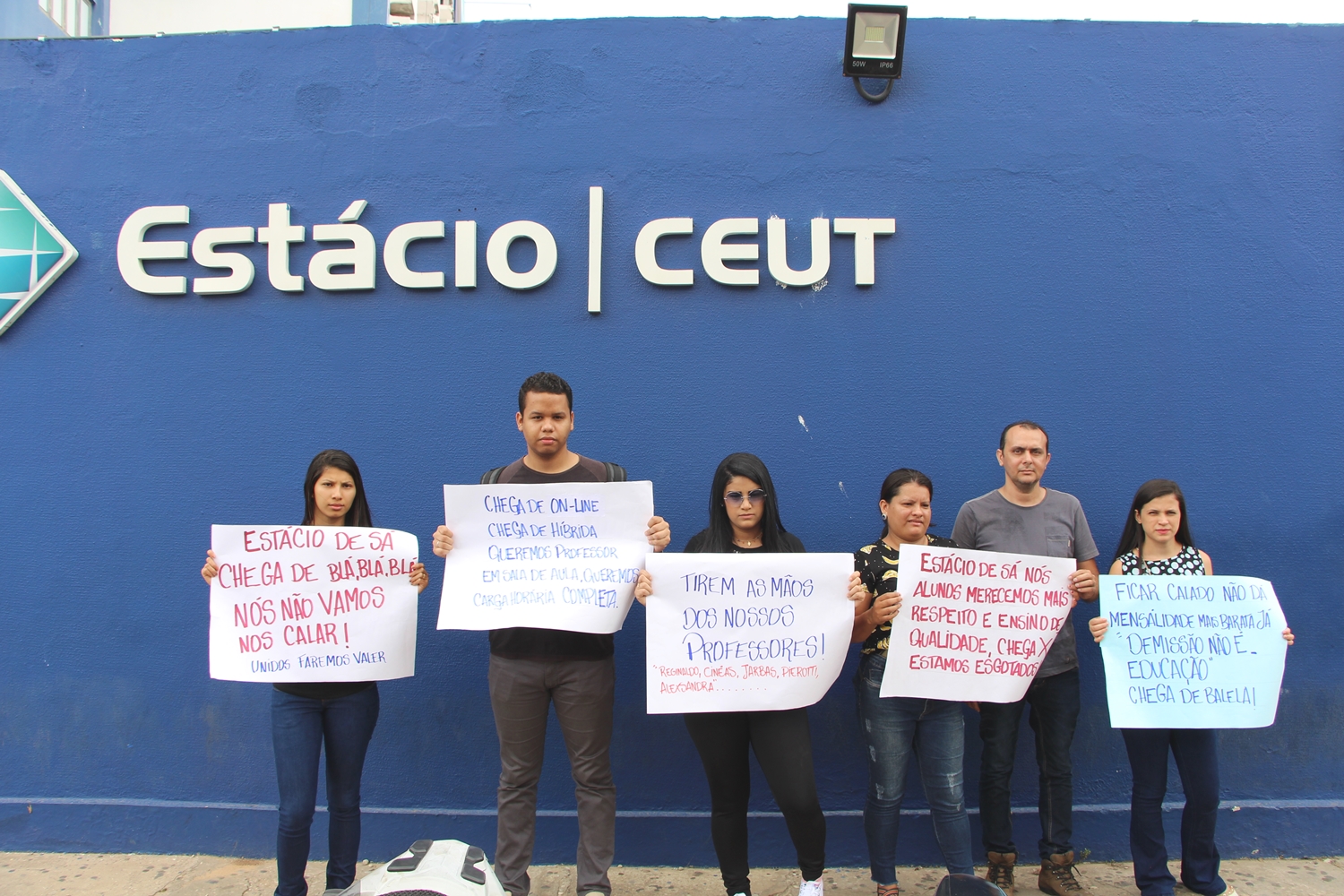 Manifestantes reunidos em frente a faculdade