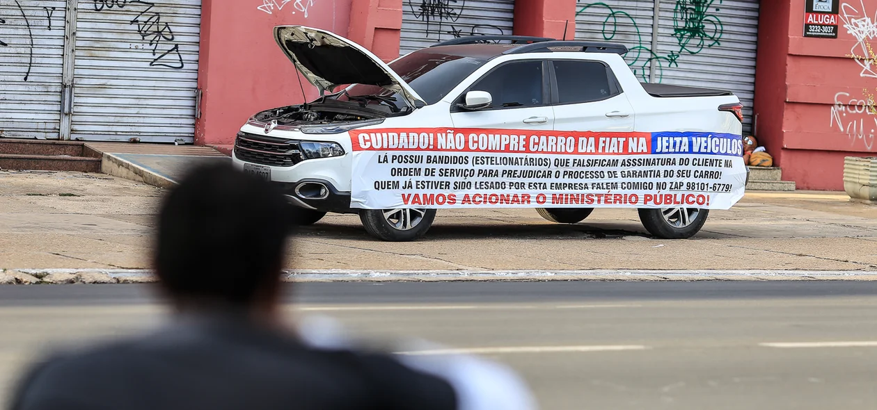 Rapaz lendo a faixa no carro 