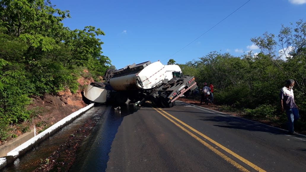 Veículo tombado derramando óleo pela pista